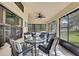 Enclosed patio featuring ample seating and views of the lush backyard at 11321 Copley Ct, Spring Hill, FL 34609