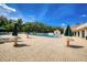 Bright community pool area surrounded by tables and lush landscaping on a sunny day at 11321 Copley Ct, Spring Hill, FL 34609
