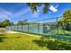 A tennis court with green fencing at 11321 Copley Ct, Spring Hill, FL 34609