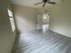 Bedroom featuring neutral walls and gray wood flooring at 11843 Fennemore Way, Parrish, FL 34219