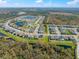 Aerial view showcasing a neighborhood with ponds and well-maintained homes at 13103 Wildflower Meadow Dr, Riverview, FL 33579