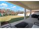 Inviting covered back patio with outdoor seating and a lush backyard featuring a playground at 13103 Wildflower Meadow Dr, Riverview, FL 33579