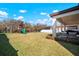 A spacious backyard with a playset, green lawn, and partial fencing provides a perfect outdoor retreat at 13103 Wildflower Meadow Dr, Riverview, FL 33579