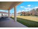 A large backyard featuring a covered patio, a playset, and a well-maintained lawn with a white fence at 13103 Wildflower Meadow Dr, Riverview, FL 33579