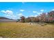 Large backyard with a well-maintained lawn, playset, and garden beds, creating a versatile outdoor space at 13103 Wildflower Meadow Dr, Riverview, FL 33579