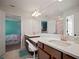 Bright bathroom featuring double sink vanity, white countertops, and large mirror at 13103 Wildflower Meadow Dr, Riverview, FL 33579