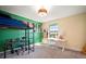 Bright bedroom featuring loft bed, skateboard decor, and a desk by the window at 13103 Wildflower Meadow Dr, Riverview, FL 33579