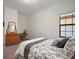 Bright bedroom with a window featuring a comfortable bed, and vintage-style desk at 13103 Wildflower Meadow Dr, Riverview, FL 33579