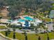Aerial view of a stunning community center with a pool, a playground, and lush landscaping at 13103 Wildflower Meadow Dr, Riverview, FL 33579