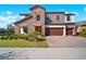 Two story home featuring stone accents, a three-car garage, and well maintained landscaping at 13103 Wildflower Meadow Dr, Riverview, FL 33579