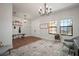 Bright foyer features a modern chandelier, wood look flooring, and a large window at 13103 Wildflower Meadow Dr, Riverview, FL 33579