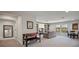 Spacious game room with large windows, built-in bookshelves, and comfortable seating at 13103 Wildflower Meadow Dr, Riverview, FL 33579