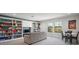 Large game room boasts custom built-ins and comfortable seating, perfect for relaxation at 13103 Wildflower Meadow Dr, Riverview, FL 33579