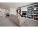 Upstairs game room boasts built-in bookshelves and a gray sofa at 13103 Wildflower Meadow Dr, Riverview, FL 33579
