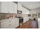 Bright kitchen with white cabinets, decorative backsplash and stainless steel appliances at 13103 Wildflower Meadow Dr, Riverview, FL 33579