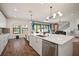 Open concept view of kitchen island with stainless steel dishwasher and sink with open concept living at 13103 Wildflower Meadow Dr, Riverview, FL 33579