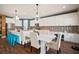 Bright eat-in kitchen with white cabinets, oversized island with seating and decorative backsplash at 13103 Wildflower Meadow Dr, Riverview, FL 33579