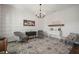 Cozy living room with wood-look flooring and a view of a bright shelf and wine storage at 13103 Wildflower Meadow Dr, Riverview, FL 33579