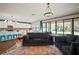 Open concept living room and kitchen with modern decor, fireplace and oversized sliding glass doors to the backyard at 13103 Wildflower Meadow Dr, Riverview, FL 33579