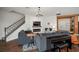 Living room with fireplace and stairs featuring an open design with dark wood-look flooring at 13103 Wildflower Meadow Dr, Riverview, FL 33579