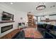 Open-concept living room featuring a fireplace, modern lighting, and seamless flow to the kitchen at 13103 Wildflower Meadow Dr, Riverview, FL 33579