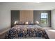 A close-up of a cozy main bedroom showcasing a stylish headboard and a large, comfortable bed with floral patterns at 13103 Wildflower Meadow Dr, Riverview, FL 33579