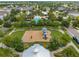 Aerial view of a community playground with swings, slides, and lush landscaping at 13103 Wildflower Meadow Dr, Riverview, FL 33579