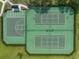 Aerial view of tennis and basketball courts with green surfaces and black fencing in a community setting at 13103 Wildflower Meadow Dr, Riverview, FL 33579