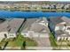 Aerial view of the house, a lake, and the community showcasing the beautiful surroundings at 14522 Woodland Spur Dr, Lithia, FL 33547