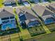 Aerial view of a well-maintained property featuring a pool, spa, and lush landscaping in a desirable neighborhood at 14522 Woodland Spur Dr, Lithia, FL 33547