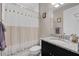 Clean bathroom with granite vanity, single sink, and a shower with a decorative curtain at 14522 Woodland Spur Dr, Lithia, FL 33547