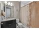 Bathroom showcasing a granite countertop, a toilet, and a shower with floral curtain at 14522 Woodland Spur Dr, Lithia, FL 33547