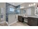 Bathroom features a large vanity with double sinks and a tile-surround glass walk-in shower at 14522 Woodland Spur Dr, Lithia, FL 33547