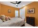 Bedroom featuring bright orange walls, a ceiling fan, and natural light from the window at 14522 Woodland Spur Dr, Lithia, FL 33547