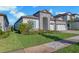Beautiful home showcasing well-manicured lawn, stone accents, and a two-car garage at 14522 Woodland Spur Dr, Lithia, FL 33547