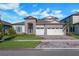 Charming single-Gathering home featuring stone accents, a well-manicured lawn, and a three-car garage at 14522 Woodland Spur Dr, Lithia, FL 33547