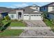 Charming two-story home with stone accents, three-car garage and well-maintained front yard at 14522 Woodland Spur Dr, Lithia, FL 33547