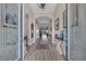 Inviting foyer showcasing beautiful light wood floors, an arched ceiling, and ornate glass paneled doors at 14522 Woodland Spur Dr, Lithia, FL 33547