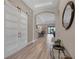 Inviting hallway with light wood flooring and a view of the dining and living areas at 14522 Woodland Spur Dr, Lithia, FL 33547