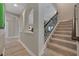 Hallway with decorative columns, hardwood floors, and carpeted stairs to the second floor at 14522 Woodland Spur Dr, Lithia, FL 33547