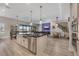 Open-concept kitchen featuring a large island, modern pendant lighting, and seamless flow to the living spaces at 14522 Woodland Spur Dr, Lithia, FL 33547