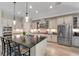 Spacious kitchen featuring a large center island, stainless steel appliances, and ample counter space at 14522 Woodland Spur Dr, Lithia, FL 33547