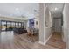 Bright open-concept living room with wood floors, modern lighting, and views of the lake at 14522 Woodland Spur Dr, Lithia, FL 33547