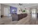 Open-concept living room features wood floors, modern decor, and seamless flow to the dining area at 14522 Woodland Spur Dr, Lithia, FL 33547