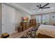 Bedroom with decorative furnishings, including wood dressers and bench seating by shuttered windows at 14522 Woodland Spur Dr, Lithia, FL 33547