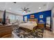 Bright main bedroom with tray ceiling, plush rug, and large windows with elegant shutters at 14522 Woodland Spur Dr, Lithia, FL 33547