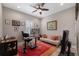 Well-lit home office with a modern desk setup, comfortable seating, and stylish decorations at 14522 Woodland Spur Dr, Lithia, FL 33547