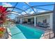 An inviting pool with a screened enclosure, a covered patio area and plenty of space for outdoor enjoyment at 14522 Woodland Spur Dr, Lithia, FL 33547