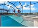 Inviting screened pool and spa with plants, alongside a serene lake view at 14522 Woodland Spur Dr, Lithia, FL 33547