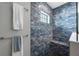 Walk-in shower features rain shower head and tiled bench with accent tile and glass surround at 14522 Woodland Spur Dr, Lithia, FL 33547